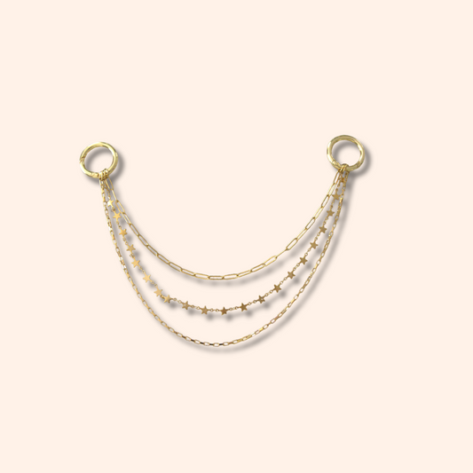 Gold chain necklace on a beige background