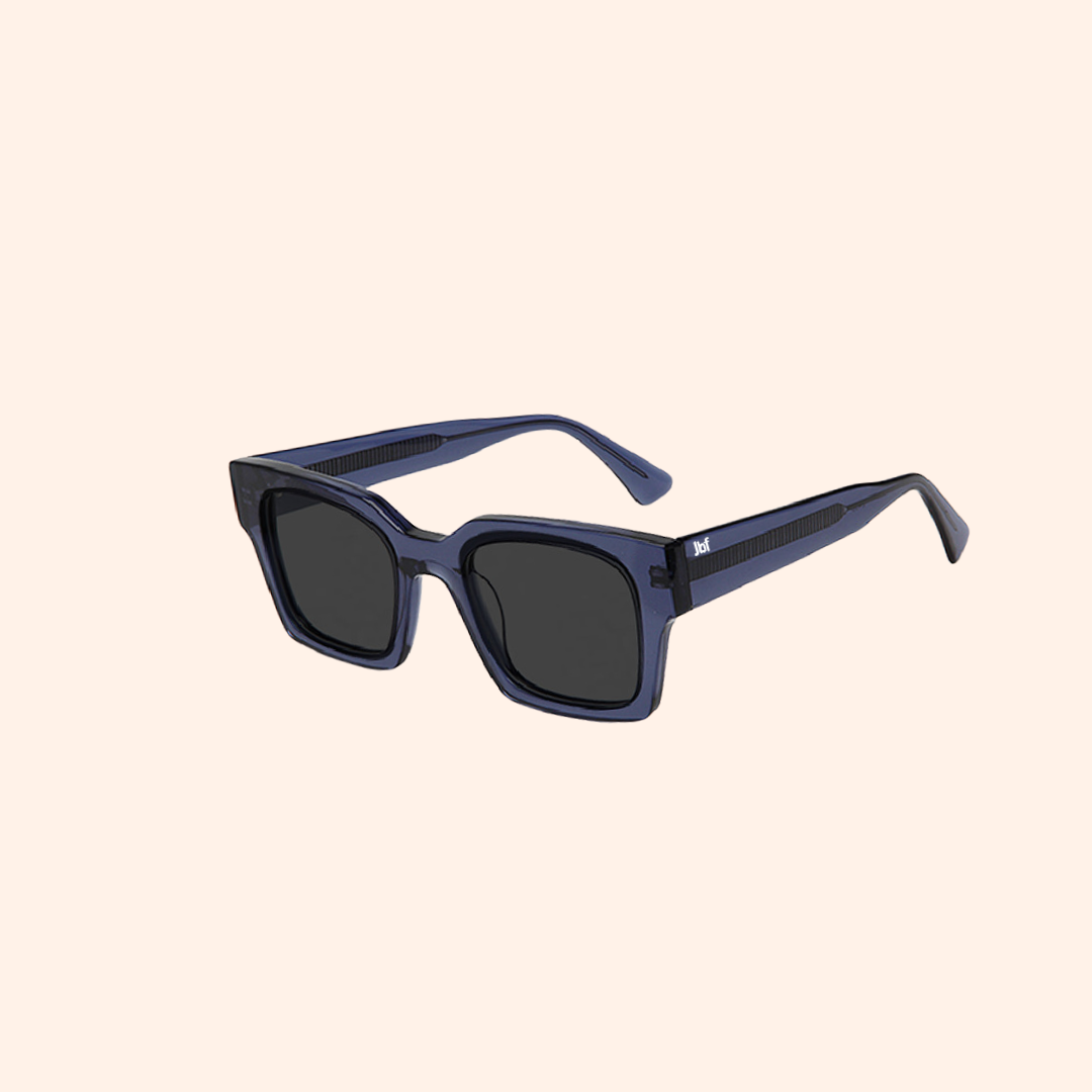 Sunglasses with gold frame and dark lenses on a white background