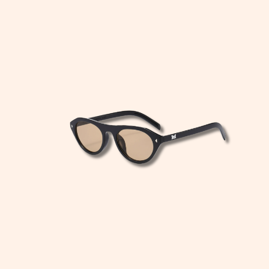 Sunglasses with black frame and beige lenses on a white background
