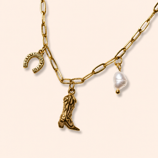 Gold western charm necklace layered with dainty gold chains